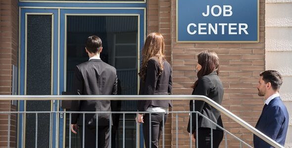 Businesspeople Standing Outside Job Center